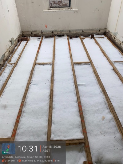 Polyester batts secured between floor joists under a raised timber floor